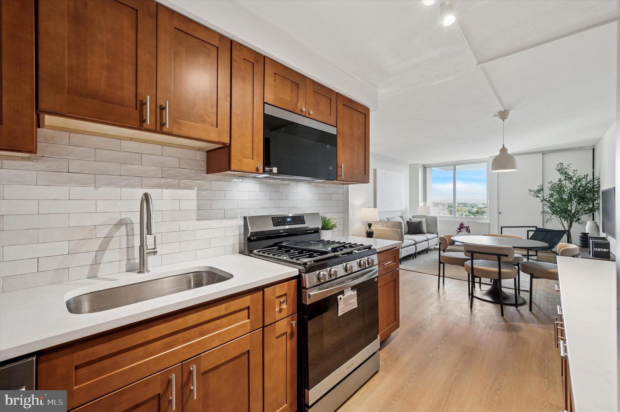 604 South Washington Square, Unit 1015 Philadelphia, PA 19106 - Photo 6 of 24 a kitchen with stainless steel appliances a stove a sink and cabinets