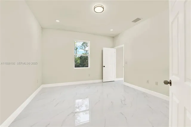 an empty room with windows and closet