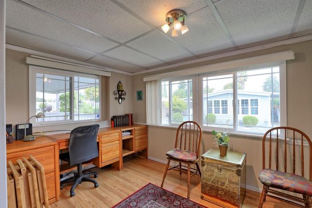 a living room with furniture fireplace and a large window