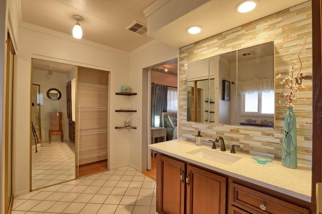 a bathroom with a shower sink and mirror