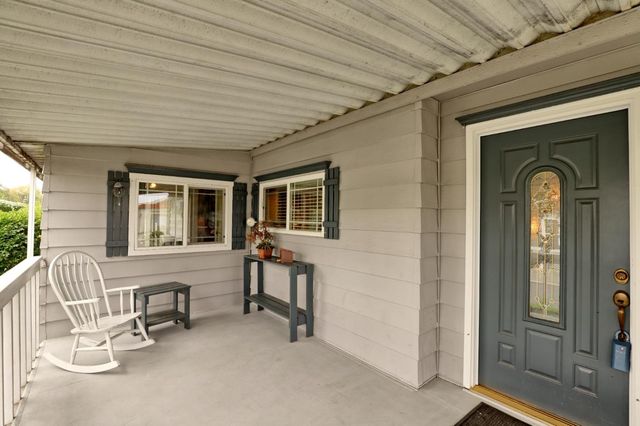 a front view of a house with outdoor seating