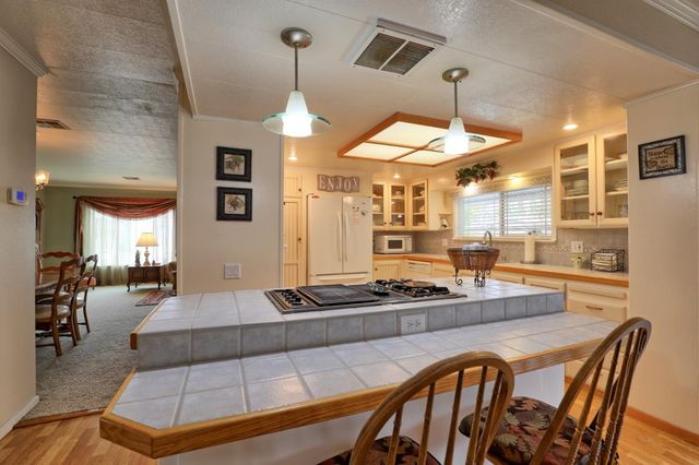 a kitchen with stainless steel appliances granite countertop a stove and a sink