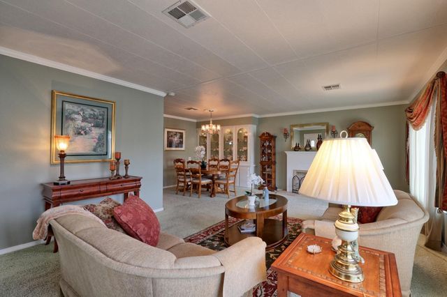 a living room with furniture and a lamp