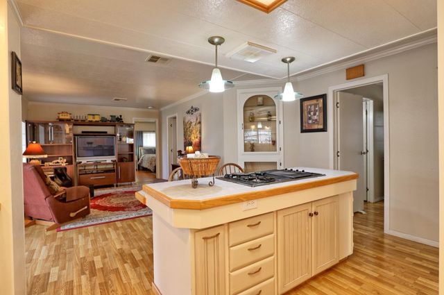 a kitchen that has a stove and a table in it