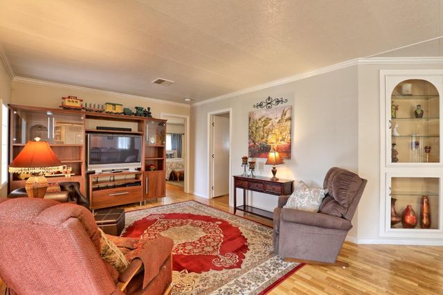 a bedroom with furniture and a flat screen tv