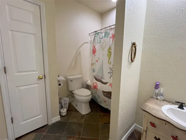 a bathroom with a toilet sink and shower