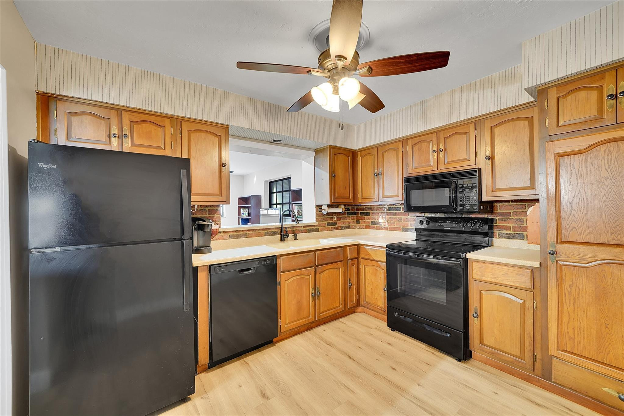 238 Southeast 3rd Street Dania Beach, FL 33004 - Photo 11 of 34 a kitchen with stainless steel appliances a refrigerator sink and cabinets