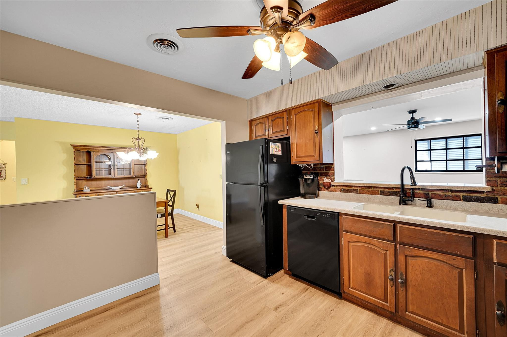238 Southeast 3rd Street Dania Beach, FL 33004 - Photo 12 of 34 a kitchen with a chandelier appliances and cabinets