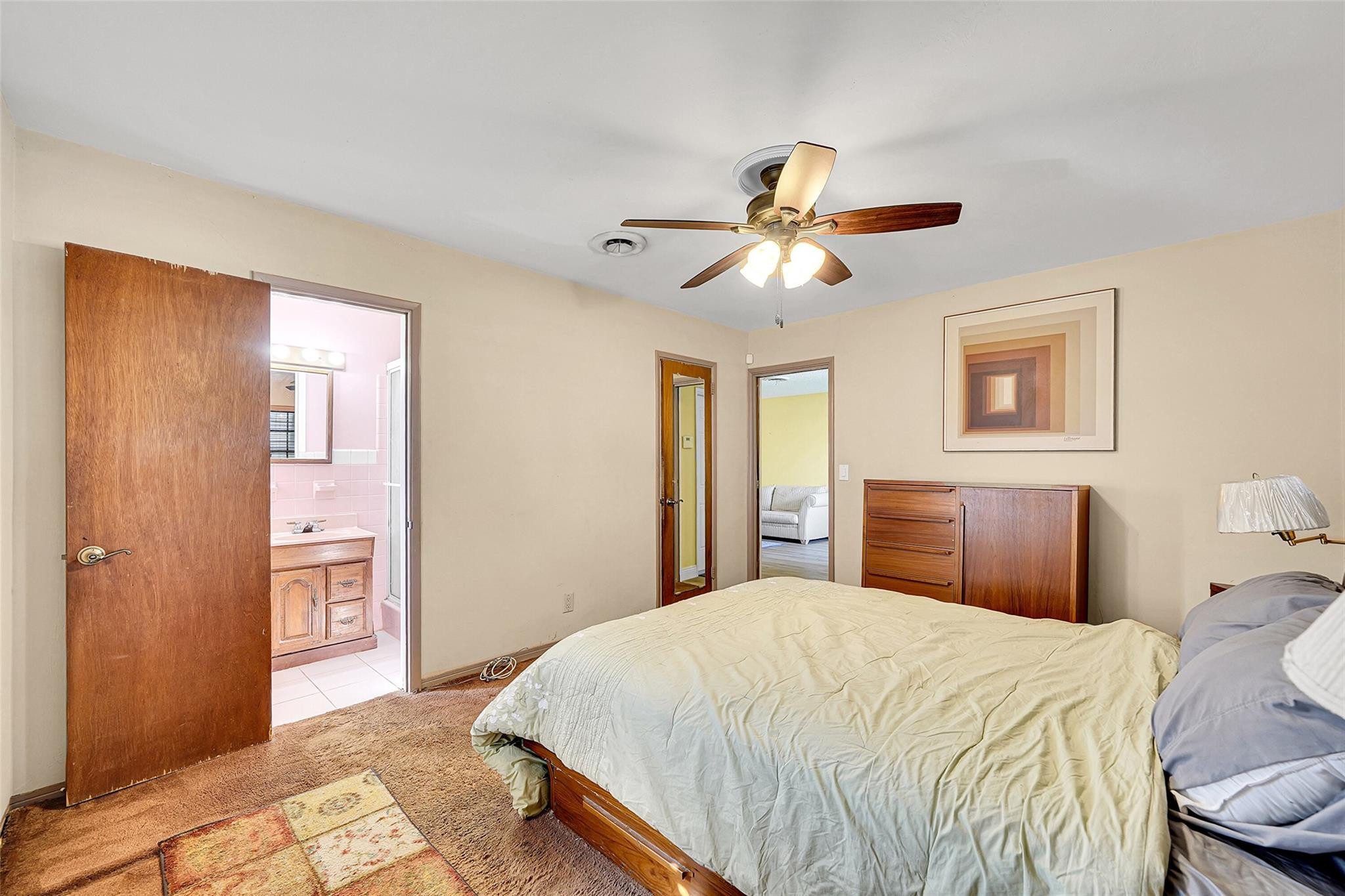 238 Southeast 3rd Street Dania Beach, FL 33004 - Photo 18 of 34 a bedroom with a large bed and a chandelier