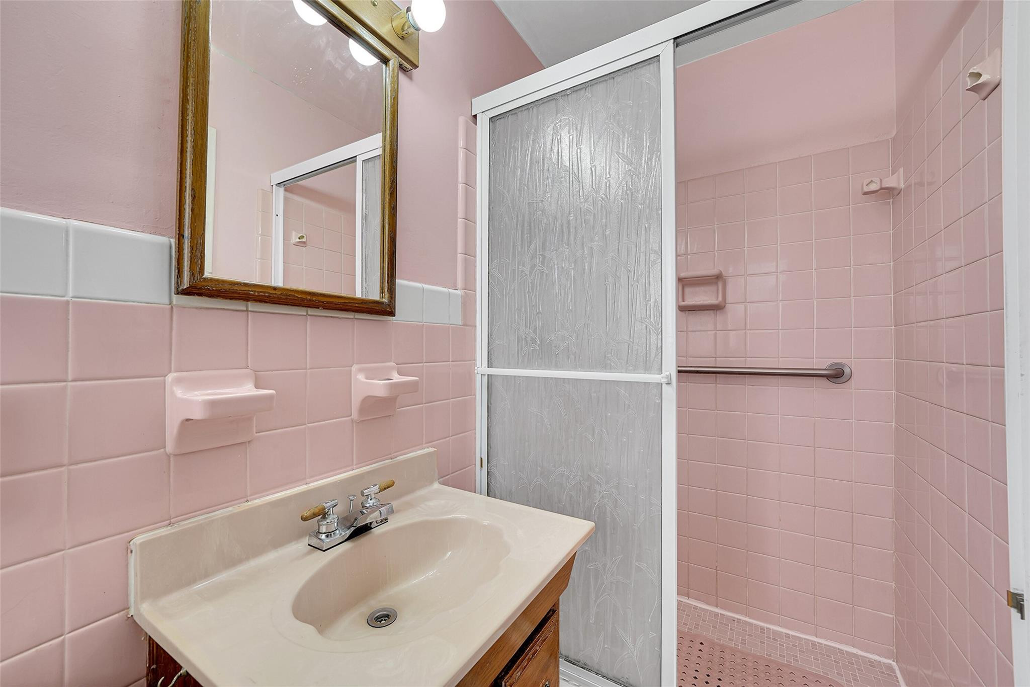 238 Southeast 3rd Street Dania Beach, FL 33004 - Photo 20 of 34 a bathroom with a sink a mirror and a shower