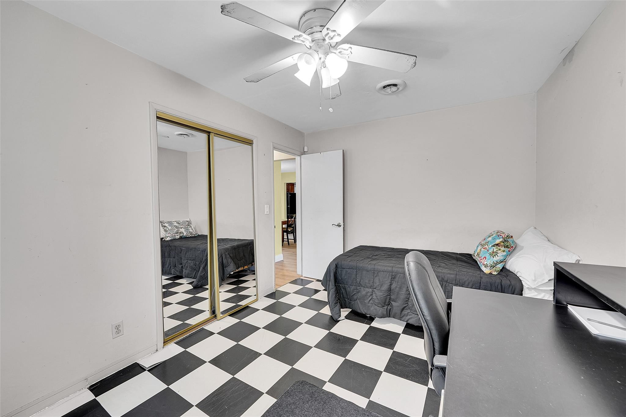 238 Southeast 3rd Street Dania Beach, FL 33004 - Photo 23 of 34 a living room with a black white checkered floor with a gaming machine and a rug