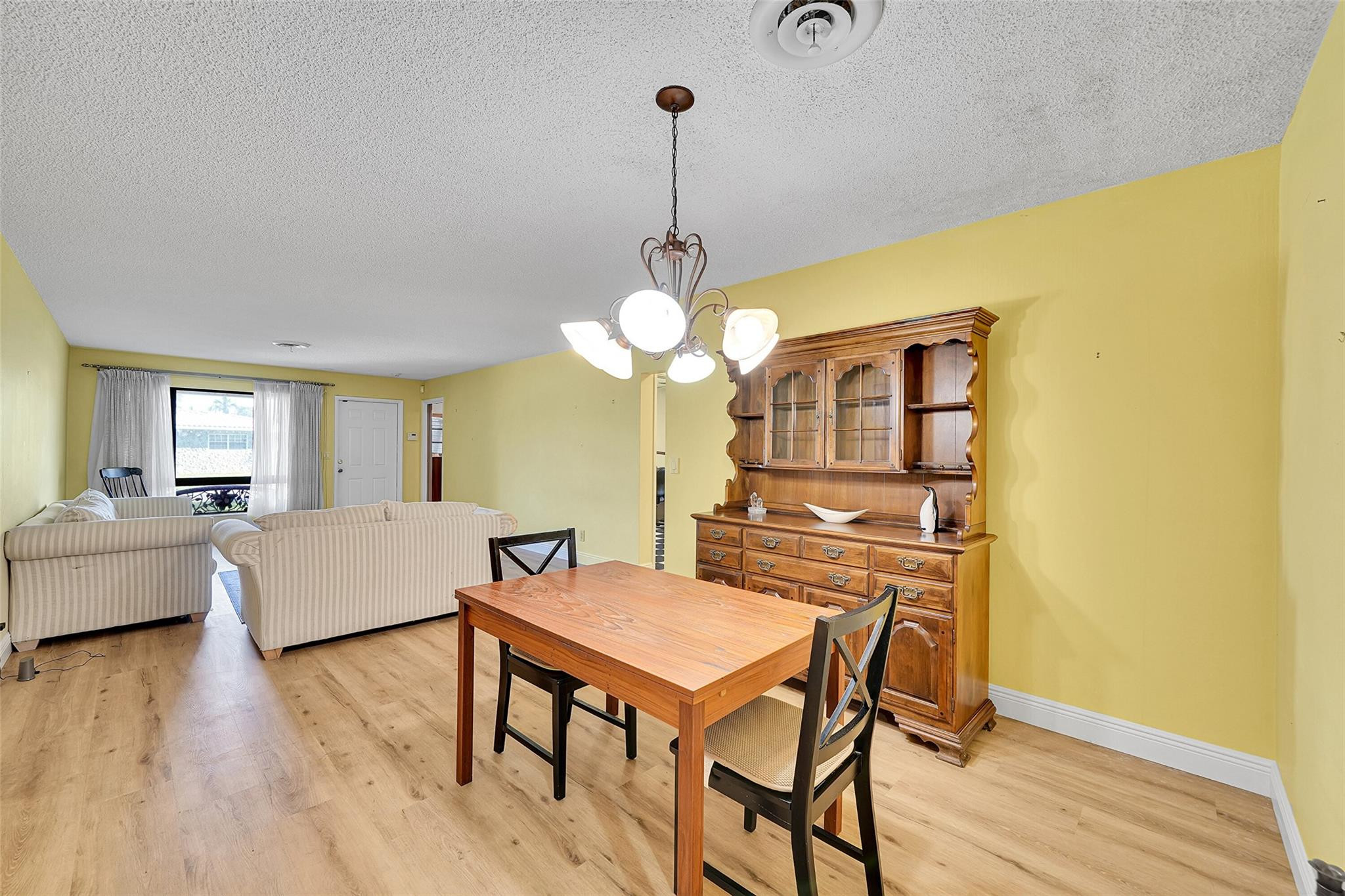 238 Southeast 3rd Street Dania Beach, FL 33004 - Photo 6 of 34 a view of a dining room with furniture and wooden floor