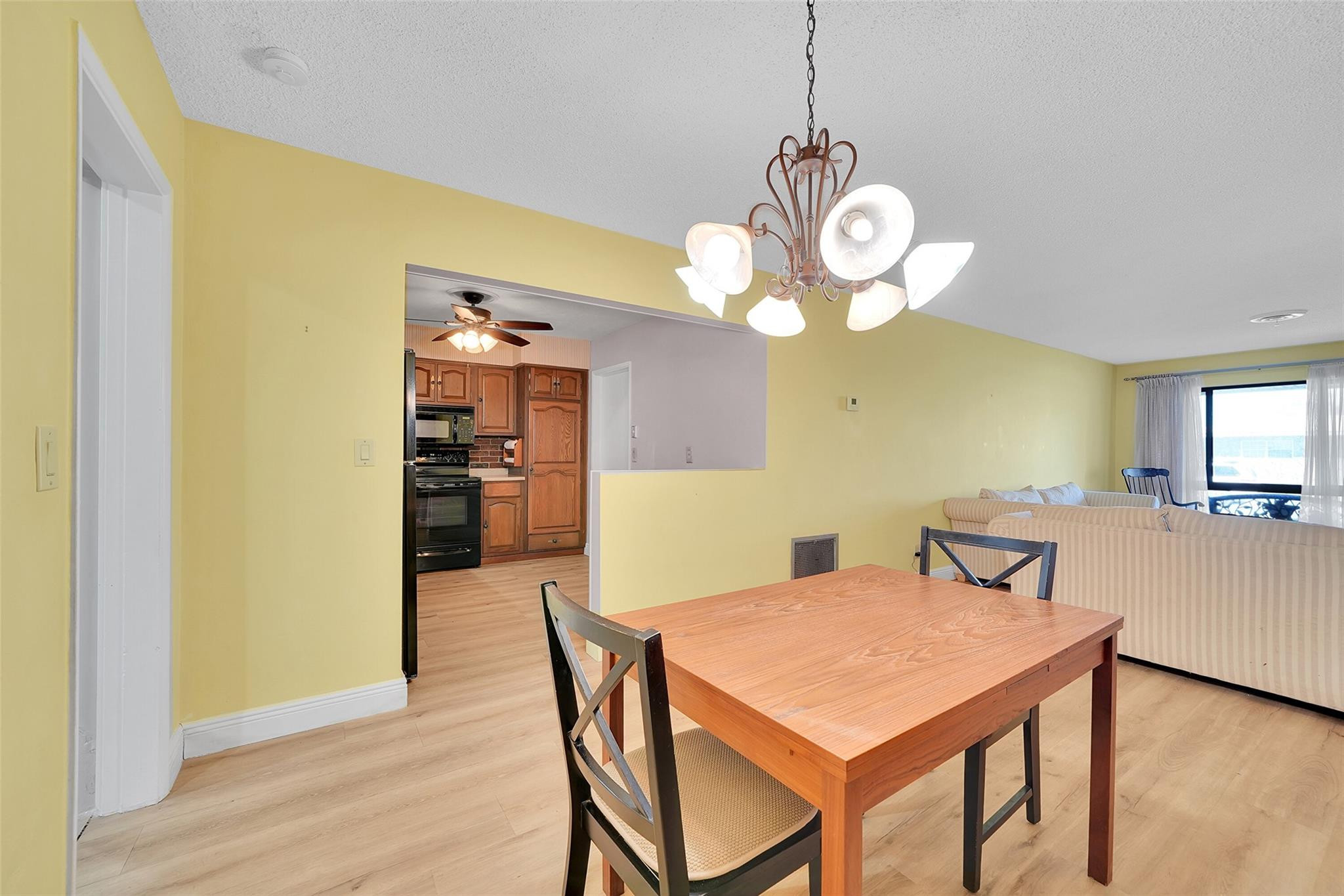 238 Southeast 3rd Street Dania Beach, FL 33004 - Photo 9 of 34 a view of a dining room and a chandelier fan