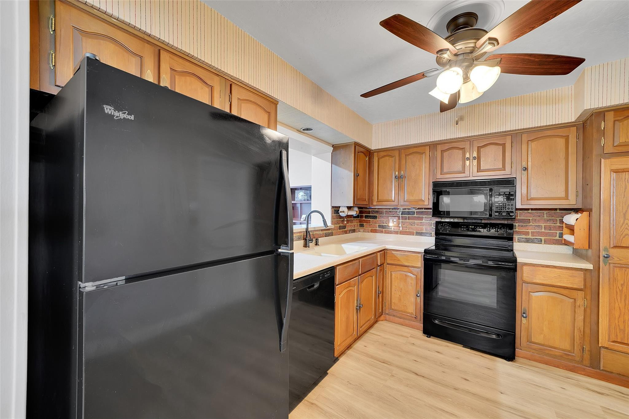 238 Southeast 3rd Street Dania Beach, FL 33004 - Photo 10 of 34 a kitchen with a refrigerator a stove top oven and cabinets