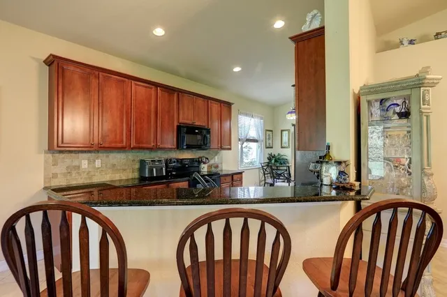 a kitchen with sink and refrigerator