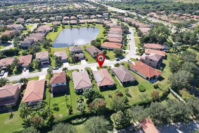 an aerial view of residential houses with outdoor space and swimming pool