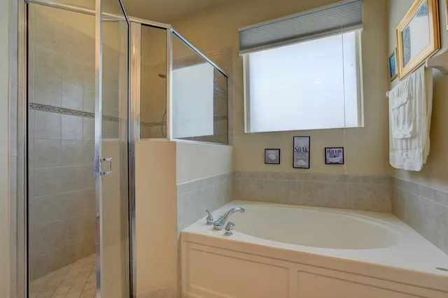 a bathroom with a tub and a shower