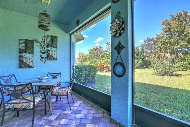 a view of porch with a table and chairs