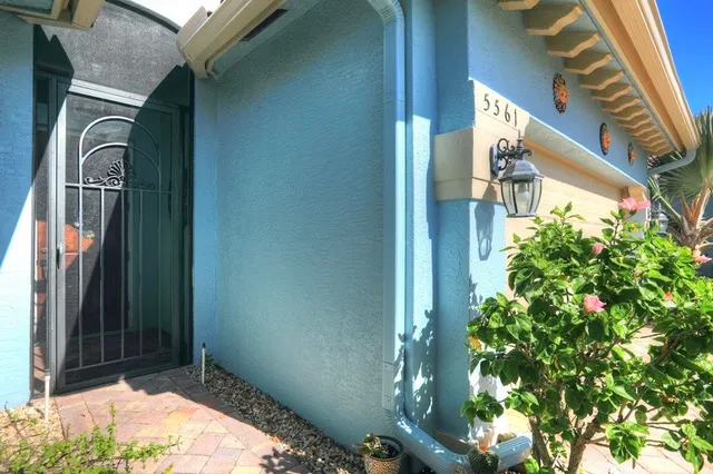 a view of a house with a flower garden