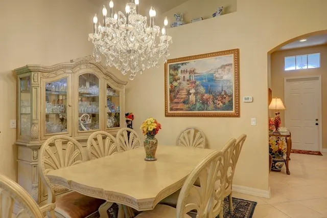 a view of a dining room with furniture and chandelier