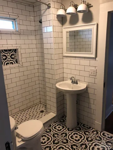 a bathroom with a sink toilet and shower