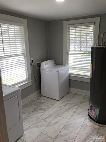 a room with a window dryer and washer