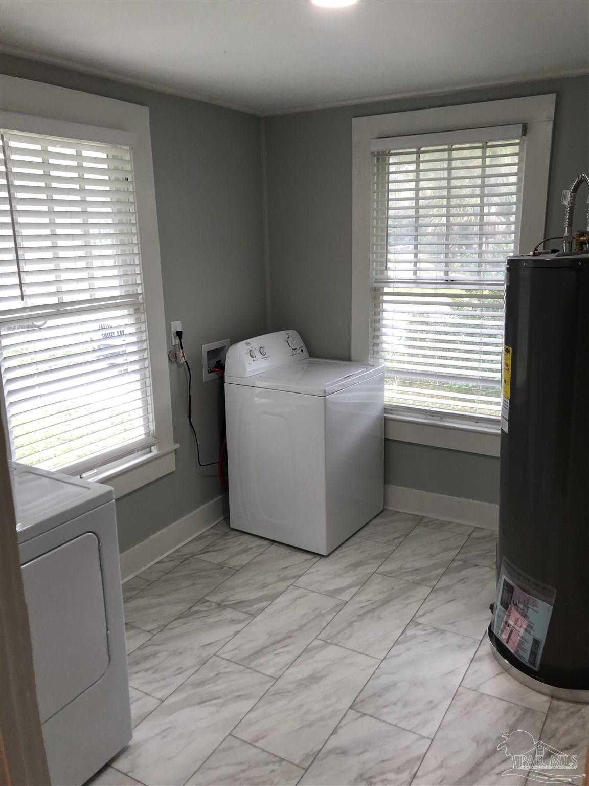 3323 West Cervantes Street Pensacola, FL 32505 - Photo 12 of 12 a room with a window dryer and washer
