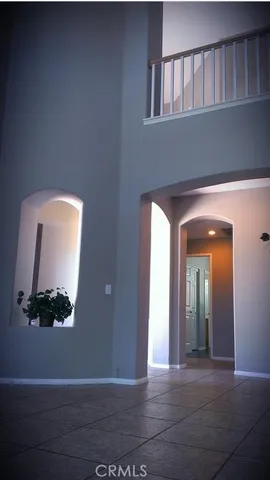 a view of a livingroom with wooden floor and a staircase