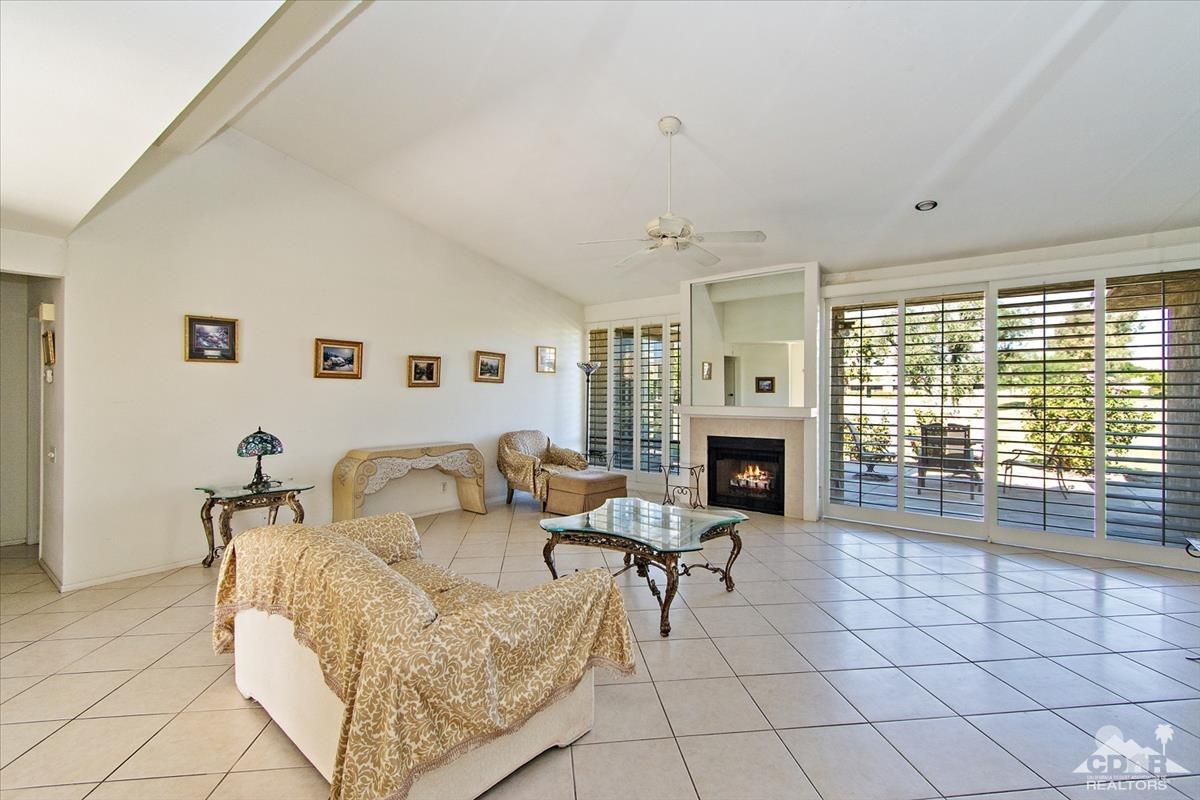 72470 Rodeo Way Rancho Mirage, CA 92270 - Photo 14 of 35 a living room with furniture a fireplace and a large window