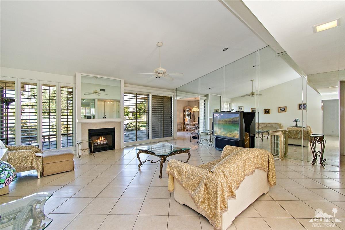72470 Rodeo Way Rancho Mirage, CA 92270 - Photo 16 of 35 a living room with furniture a fireplace and a flat screen tv