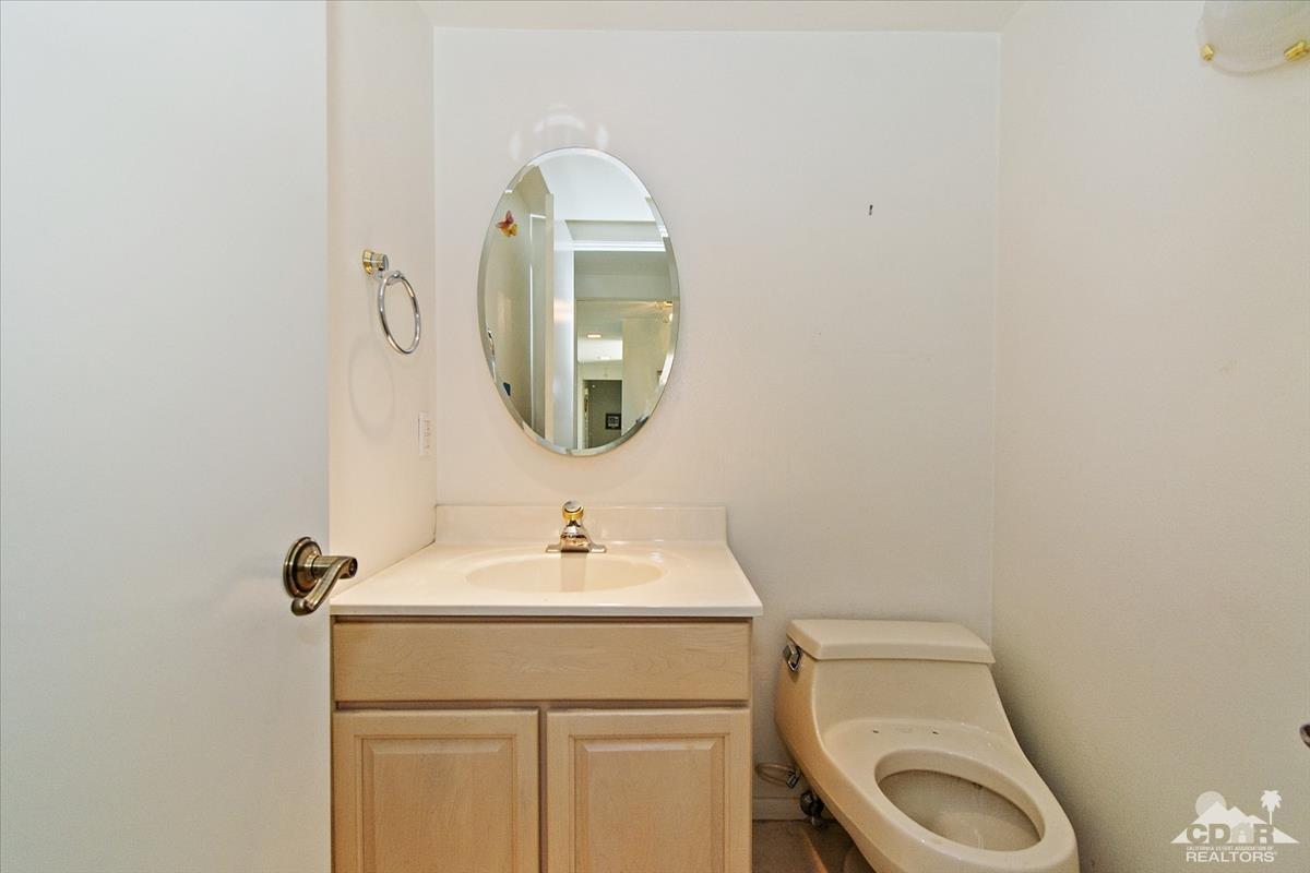72470 Rodeo Way Rancho Mirage, CA 92270 - Photo 19 of 35 a bathroom with a toilet sink and mirror