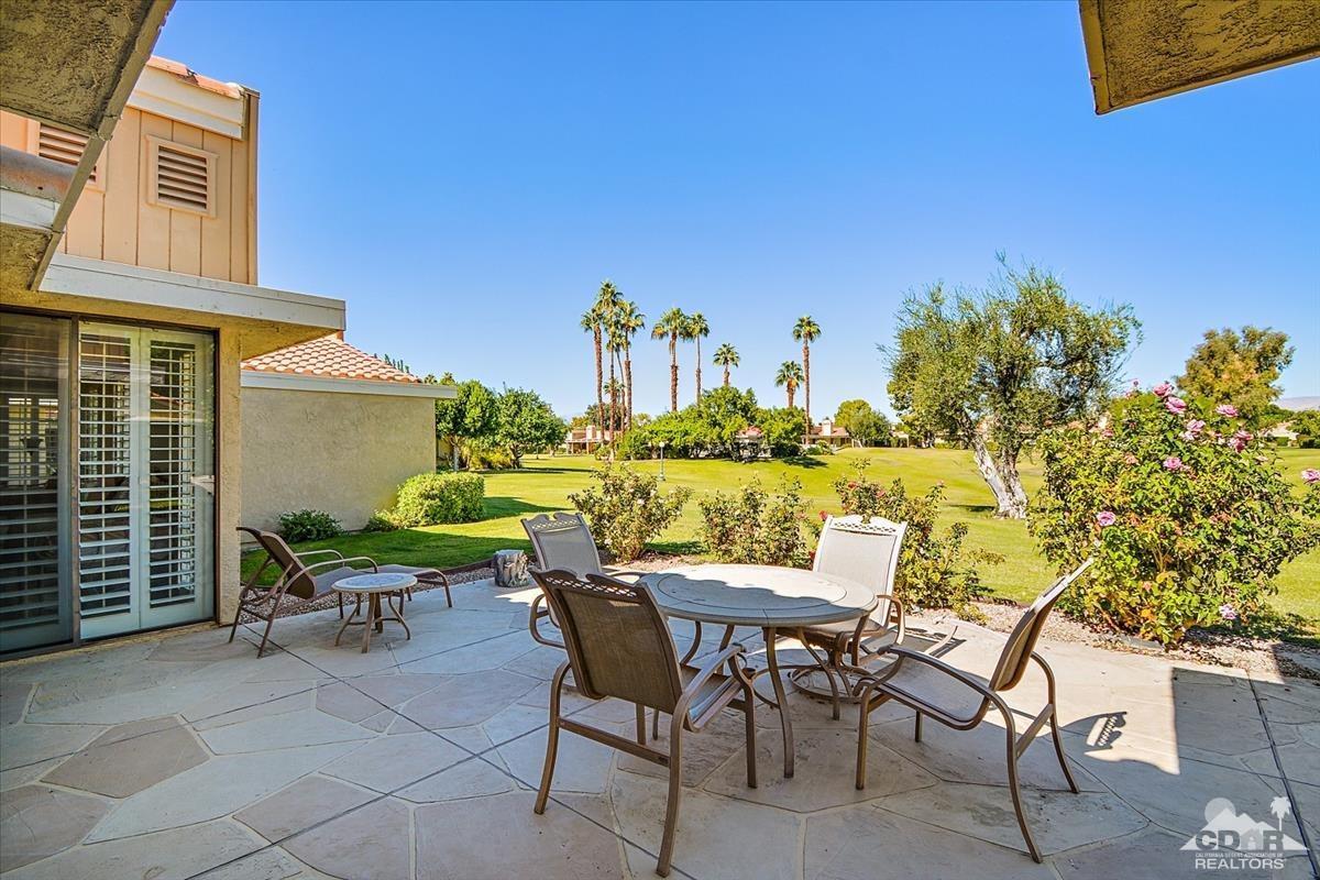 72470 Rodeo Way Rancho Mirage, CA 92270 - Photo 20 of 35 a view of a patio with table and chairs and potted plants