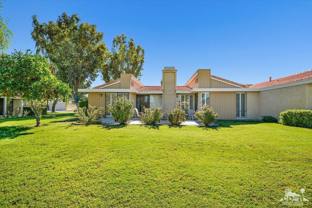 72470 Rodeo Way Rancho Mirage, CA 92270 - Photo 23 of 35 a front view of a house with a yard and trees