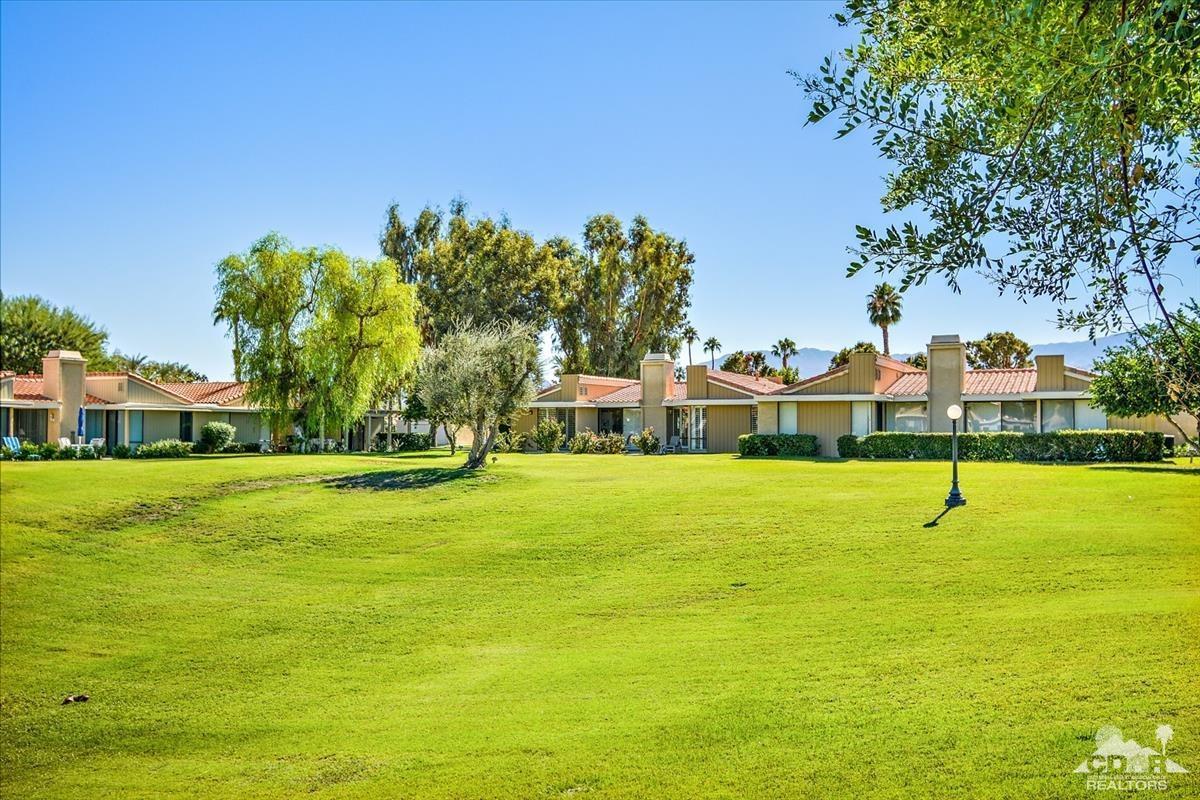 72470 Rodeo Way Rancho Mirage, CA 92270 - Photo 26 of 35 a view of a swimming pool with lawn chairs and plants