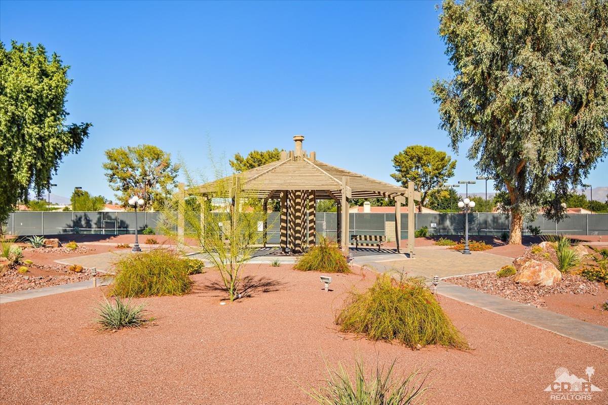 72470 Rodeo Way Rancho Mirage, CA 92270 - Photo 29 of 35 a front view of a house with a yard and garage