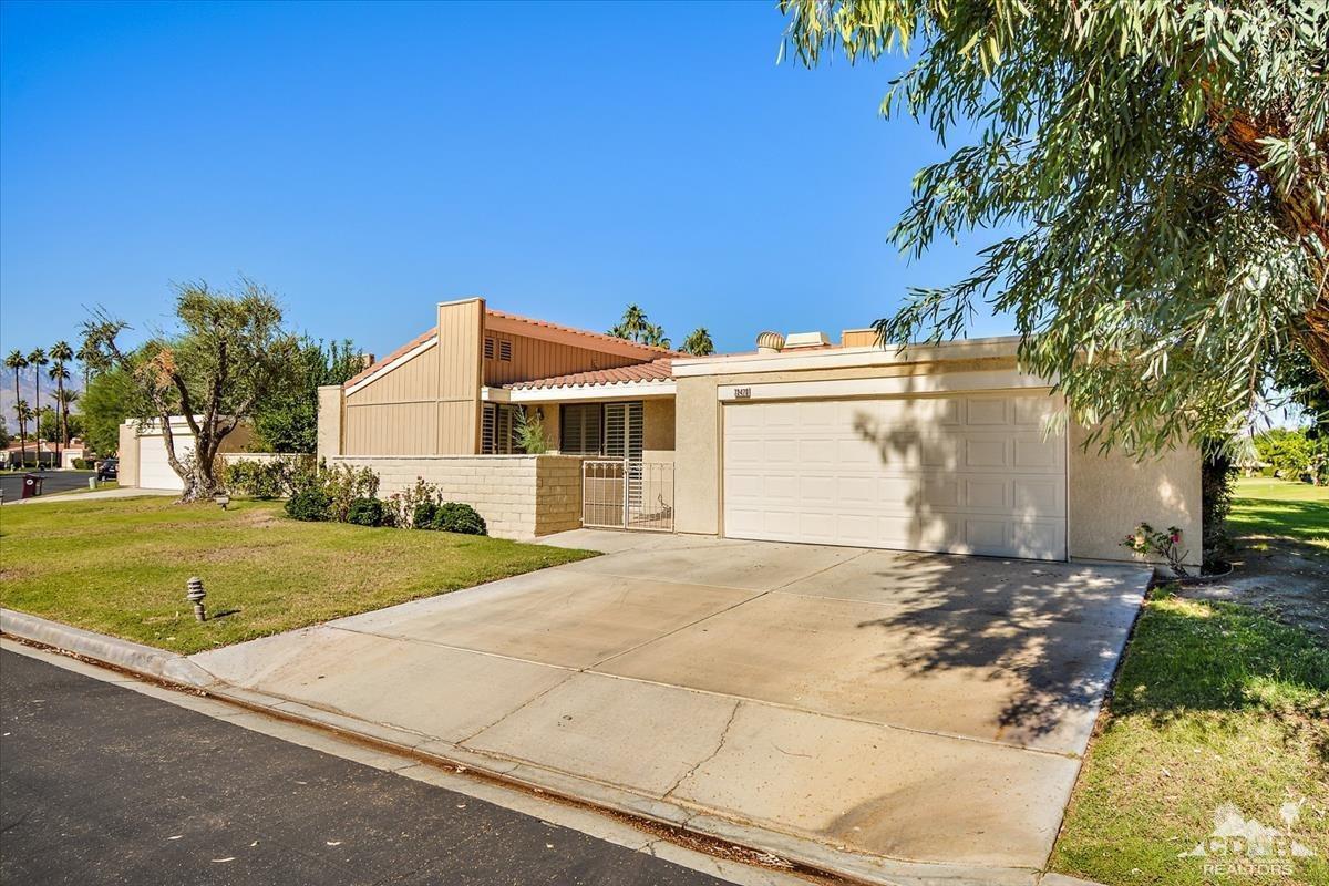 72470 Rodeo Way Rancho Mirage, CA 92270 - Photo 32 of 35 a view of a white house with a yard and large trees