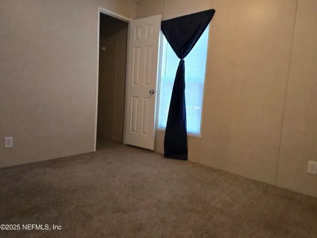 a view of an empty room with a door