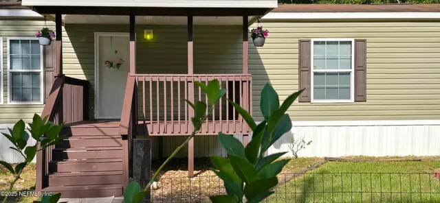 a view of balcony with wooden floor and fence