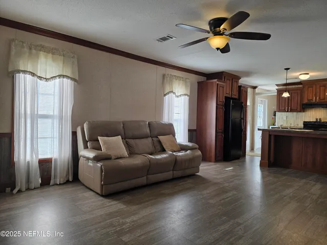a kitchen with stainless steel appliances granite countertop a stove and a wooden cabinets