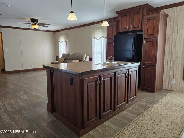 a room with a bed and a ceiling fan