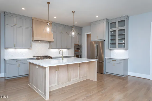 a kitchen with a white stove refrigerator and cabinets