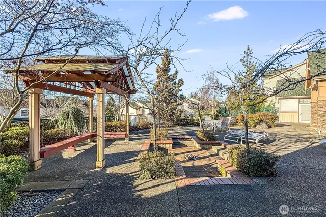 a view of a patio with a table and chairs under an umbrella