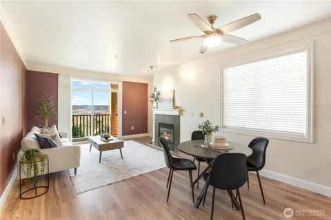 a dining room with furniture a chandelier and wooden floor