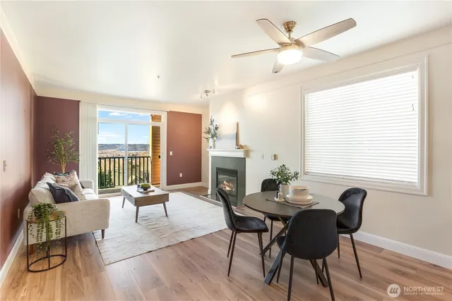 a dining room with furniture a chandelier and wooden floor