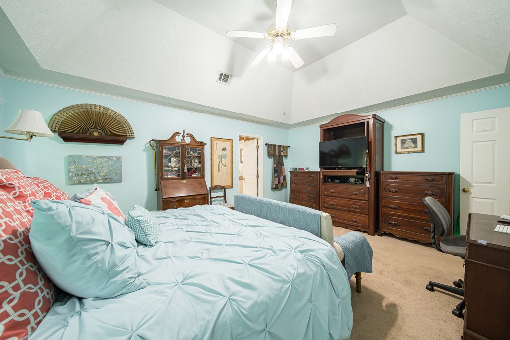 8100 Warm Springs Road Midland, GA 31820 - Photo 15 of 35 a bedroom with a large bed and a flat tv screen