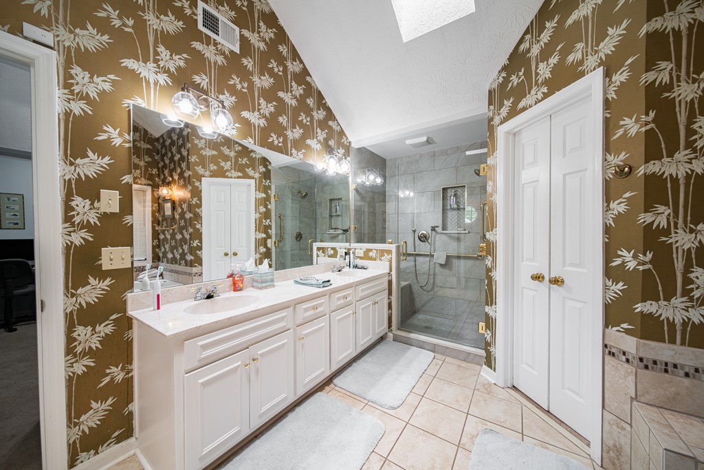 8100 Warm Springs Road Midland, GA 31820 - Photo 16 of 35 a bathroom with a sink mirror and shower