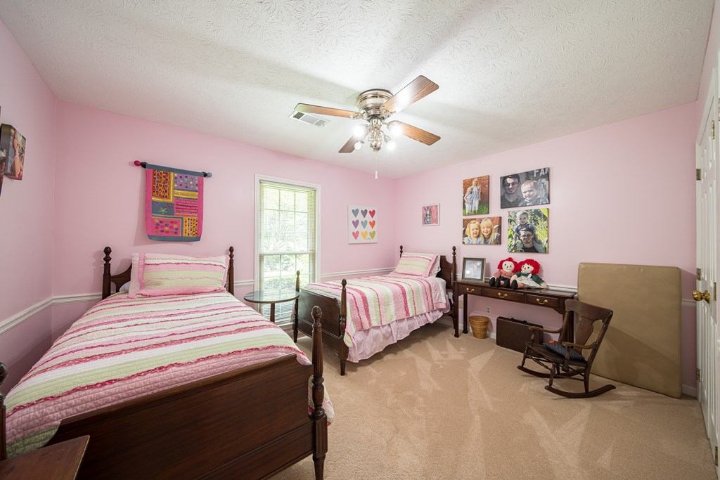 8100 Warm Springs Road Midland, GA 31820 - Photo 19 of 35 a bedroom with a bed and a desk