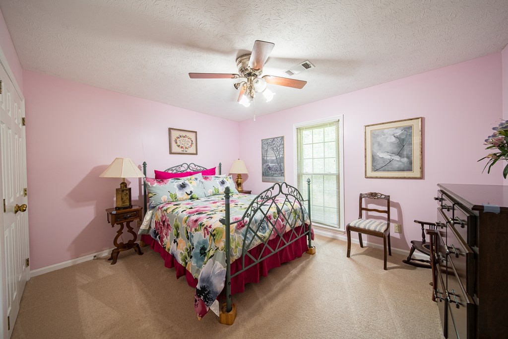 8100 Warm Springs Road Midland, GA 31820 - Photo 21 of 35 a bed room with a bed furniture and a chandelier