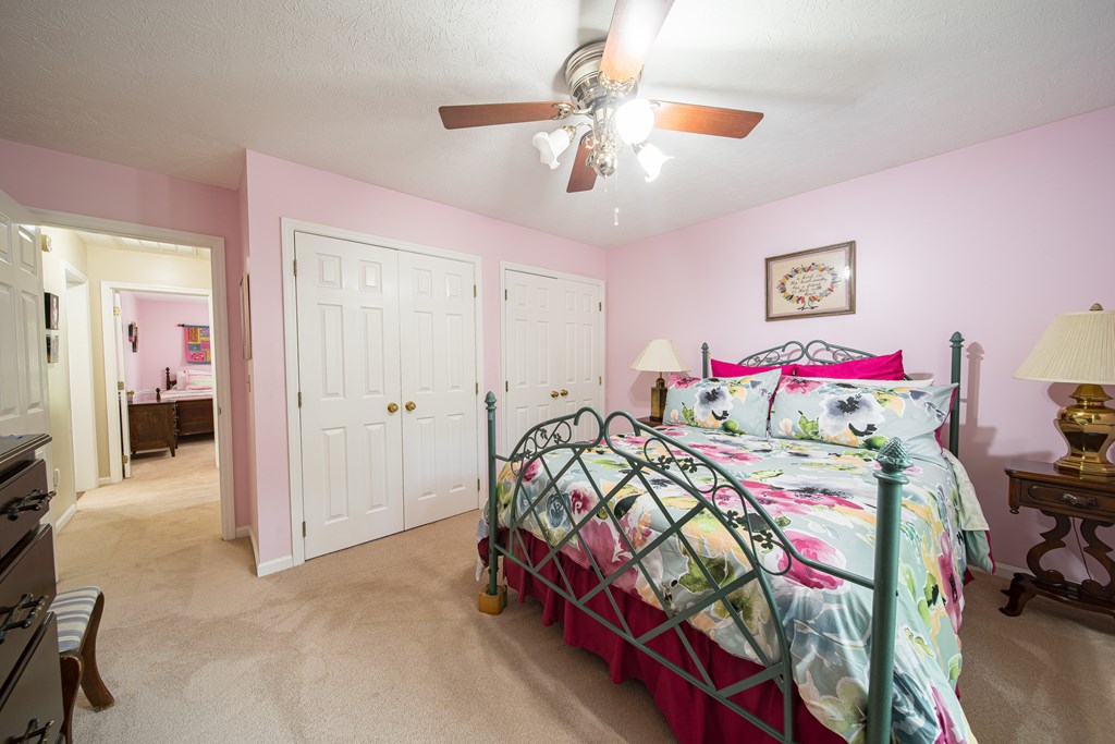 8100 Warm Springs Road Midland, GA 31820 - Photo 22 of 35 a bedroom with a bed and a chandelier