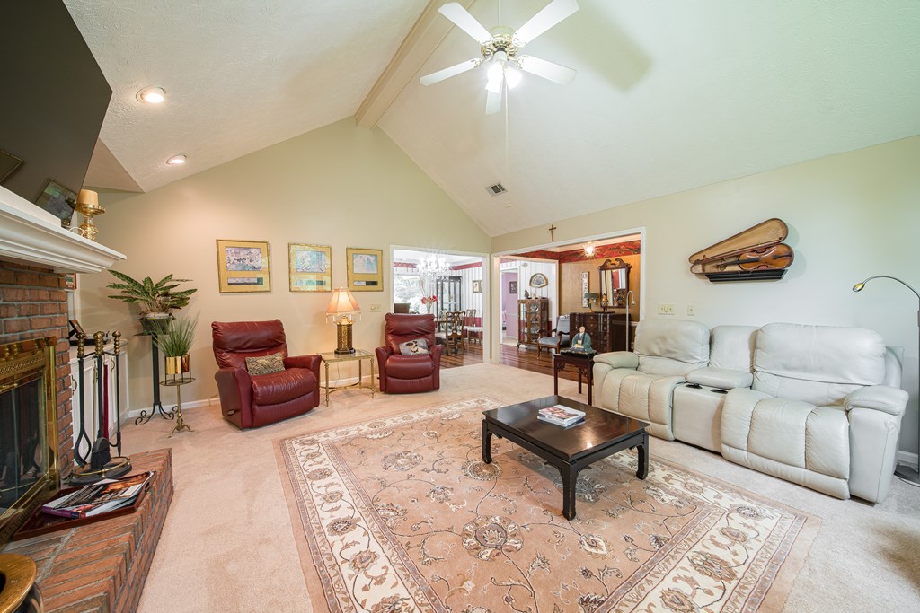 8100 Warm Springs Road Midland, GA 31820 - Photo 6 of 35 a living room with furniture a flat screen tv and a fireplace